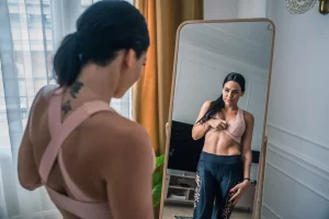 A woman checking her body out in a mirror